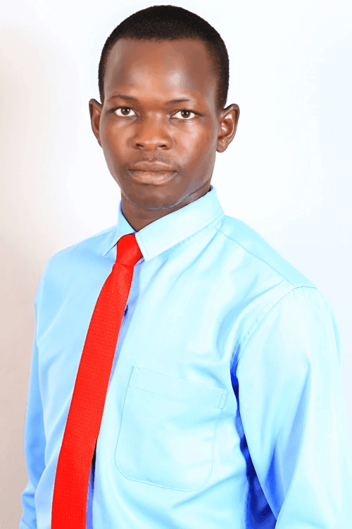 Man in a light blue shirt and red tie posing against a white background.