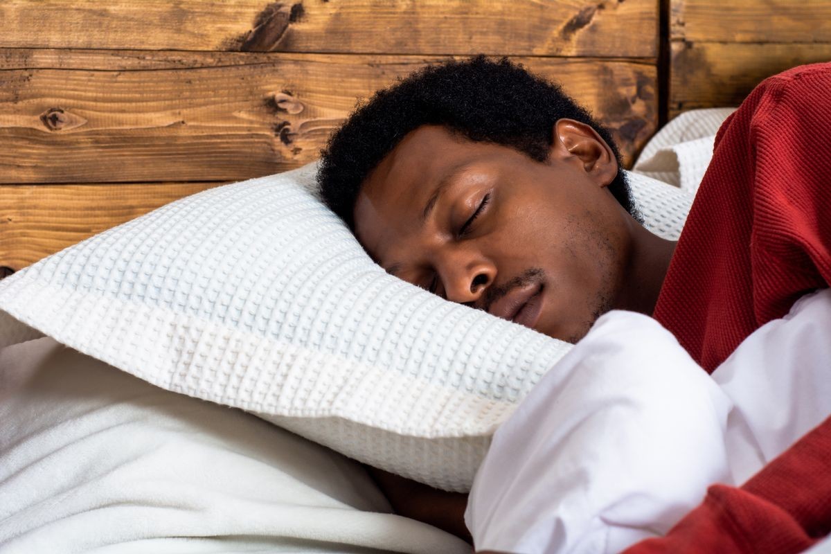 Close-up afro american man sleeping in bed